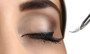 Stylists apply individual semi-permanent extensions to natural lashes to create a fuller